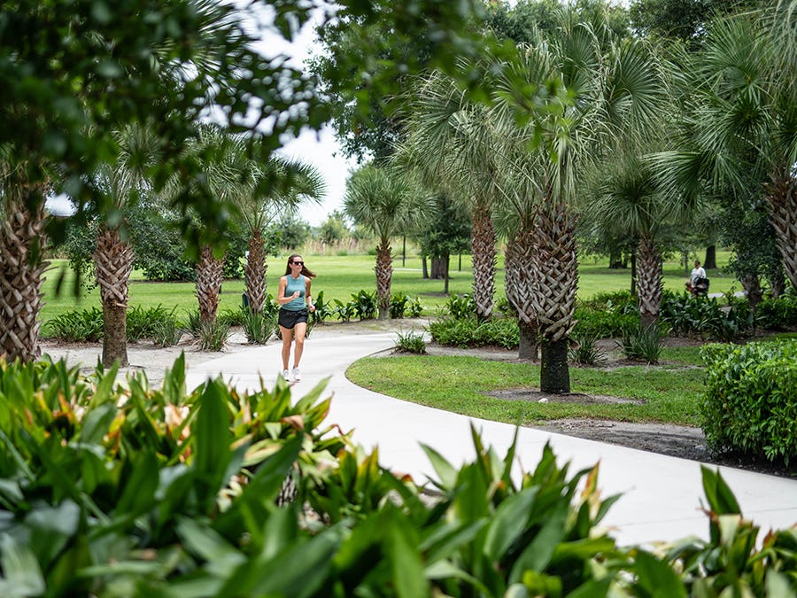 Woman running on trails at Bonnet Springs Park in Lakeland, FL